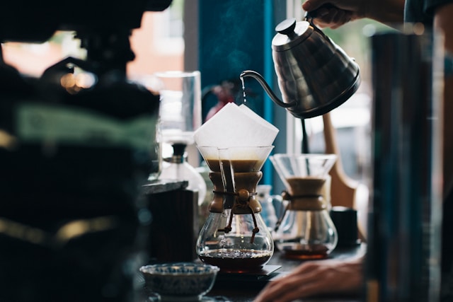 someone pours coffee into a cup