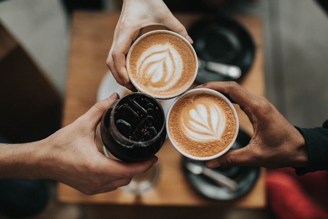 people holding drinks in their hand